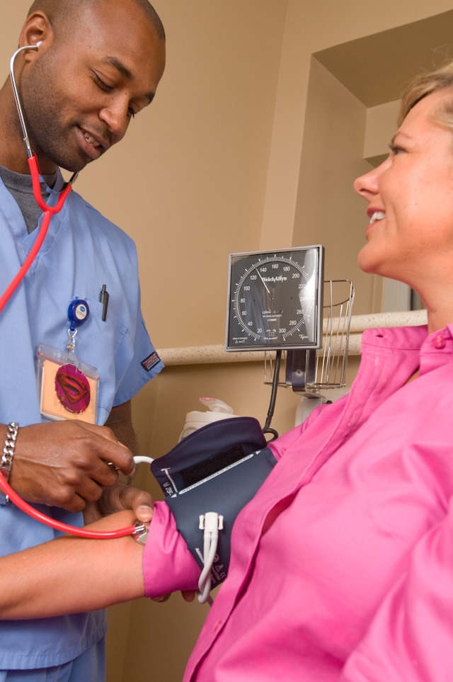 Doctor taking patient's blood pressure — a medical examination in a clinic setting